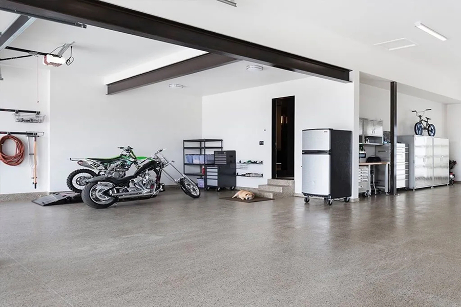 This image shows a garage with motorcycles parked in it.